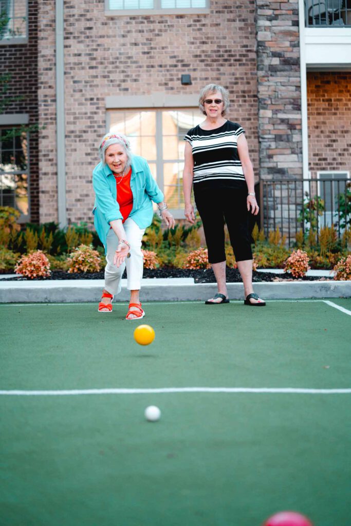 Seniors play bocee on an outdoor court