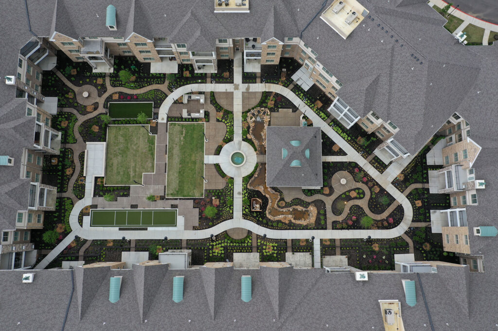 An arial view of Central Park at The Farms shows winding footpaths and ornate landscaping