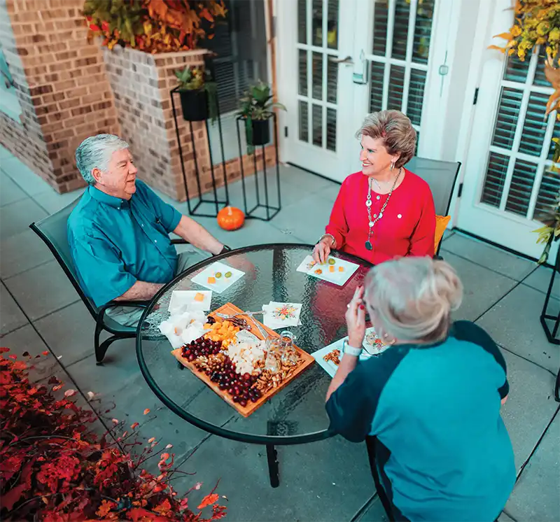 Group of friends eating together on the patio