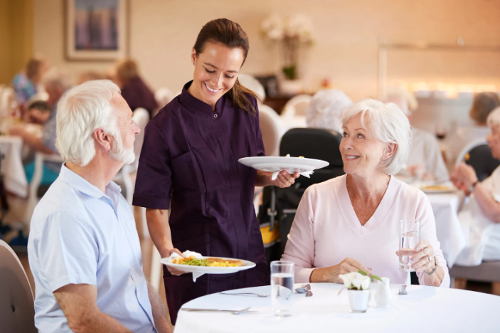 Seniors being served dinner