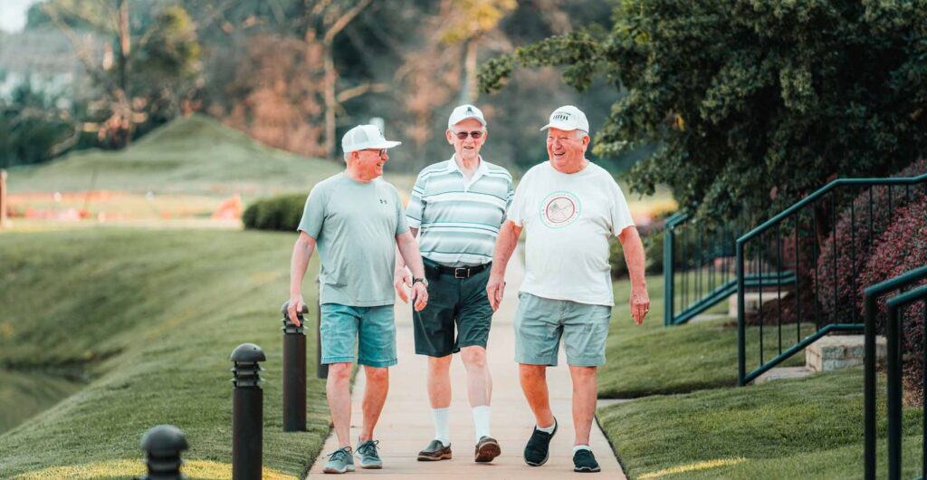 3 men walking down path